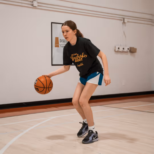 Young girl dribbling basketball