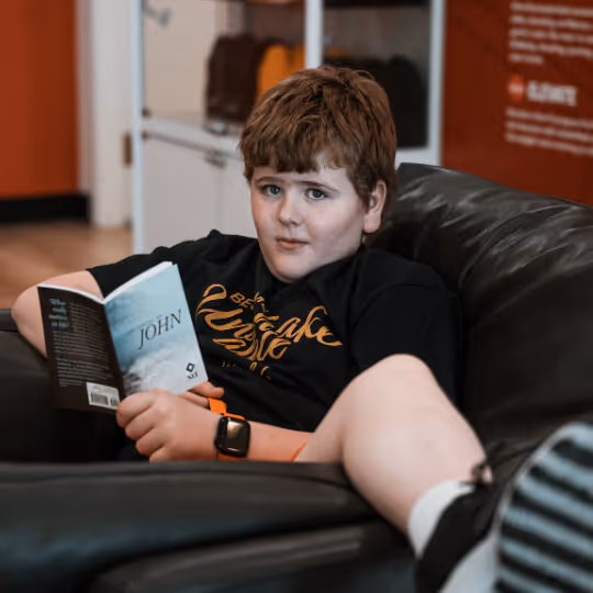 Kid sitting down with a bible